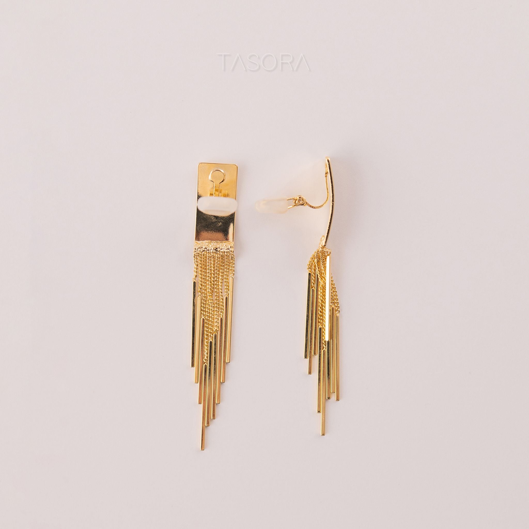 Side look of Cascade Flow golden earrings on a light background with 'TASORA' branding.
