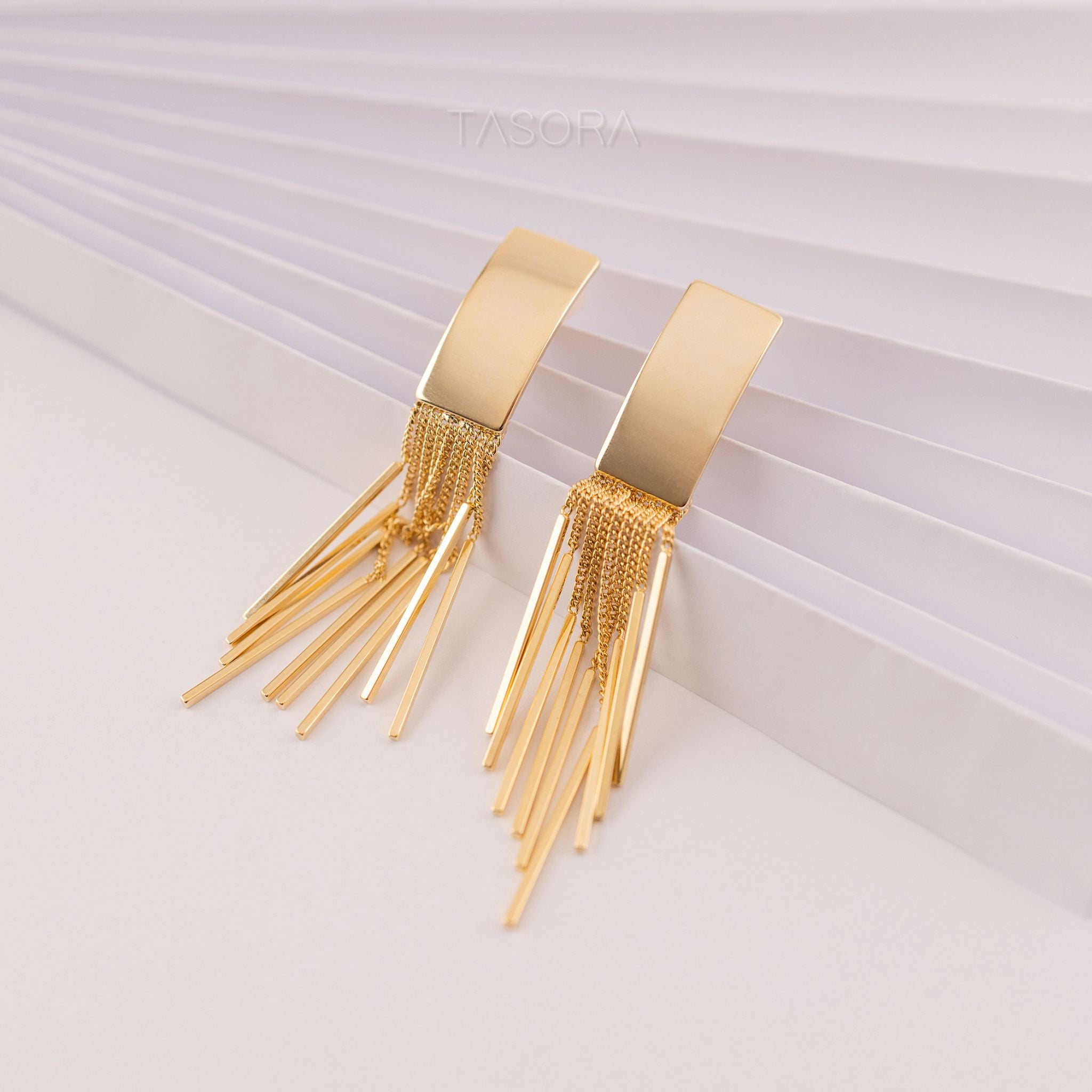 Cascade Flow Golden tassel earrings on a white background with 'TASORA' branding.