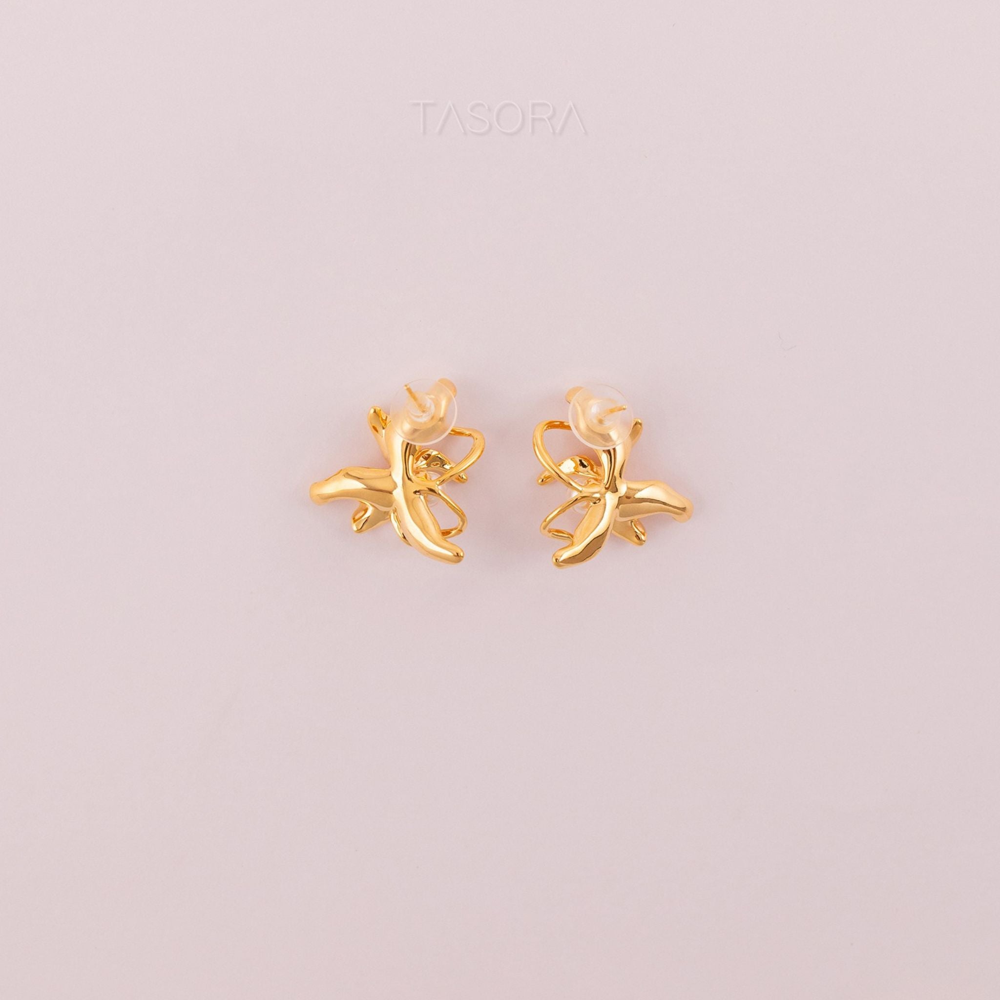 Back side of Dancing Flamenco Golden earrings on a light pink background with 'TASORA' branding.