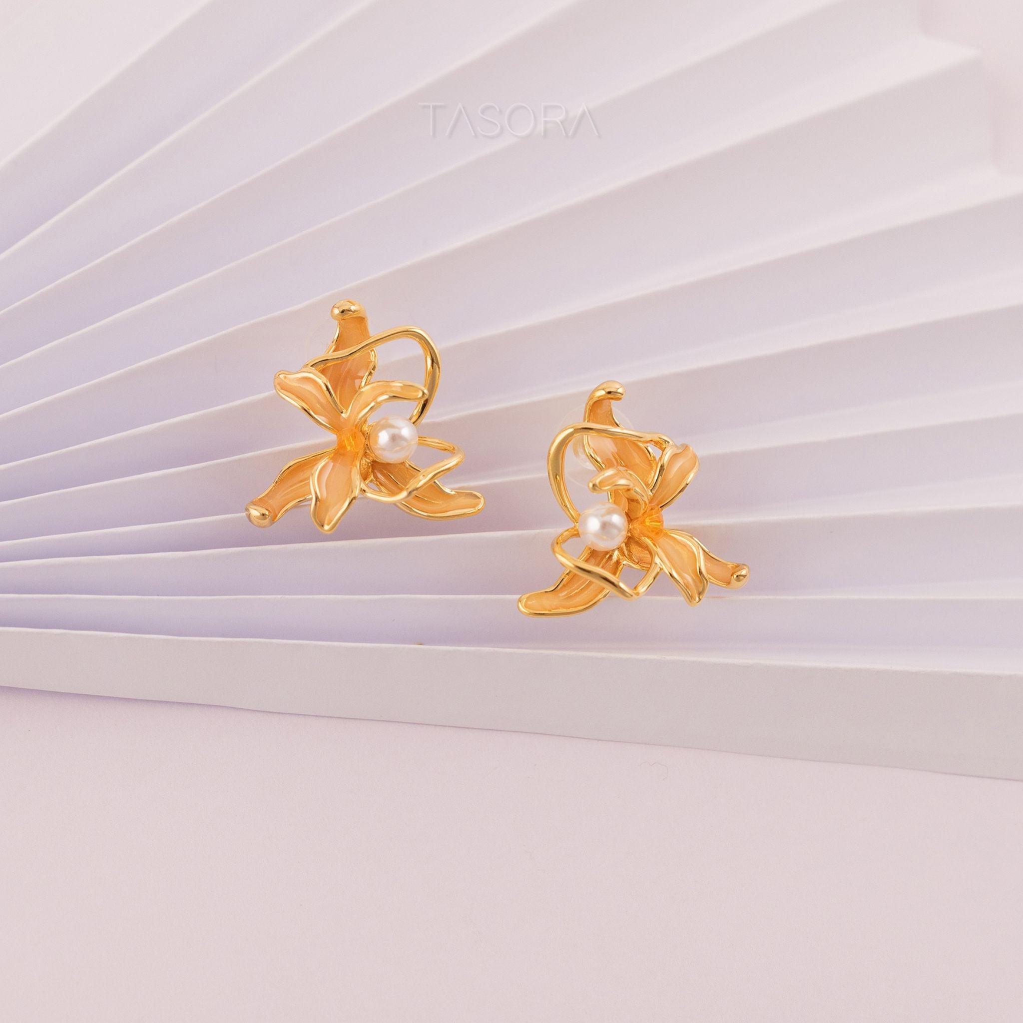 Dancing Flamenco Golden earrings with pearls on a white paper background with TASORA branding
