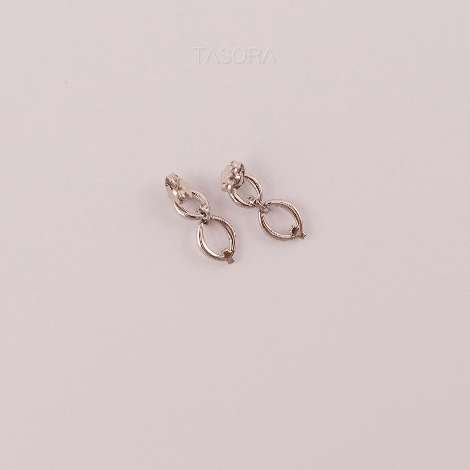 Back Side of Elior Silver earrings on a light natural background with 'TASORA' branding.