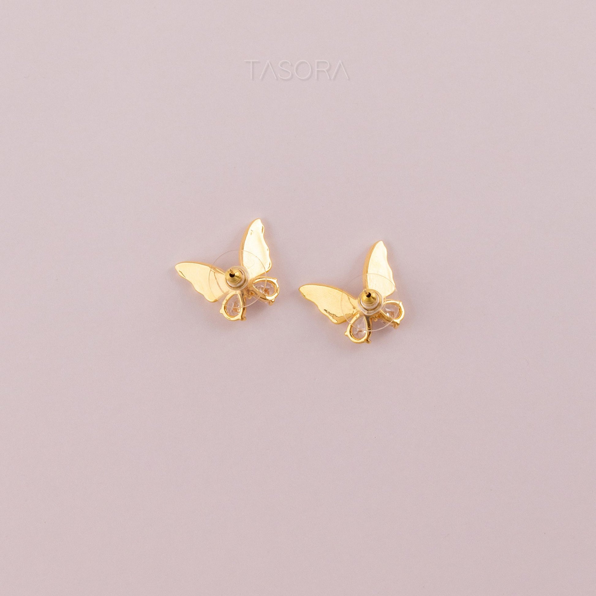 Back side of Flutter wings earrings on a light gray background with TASORA branding