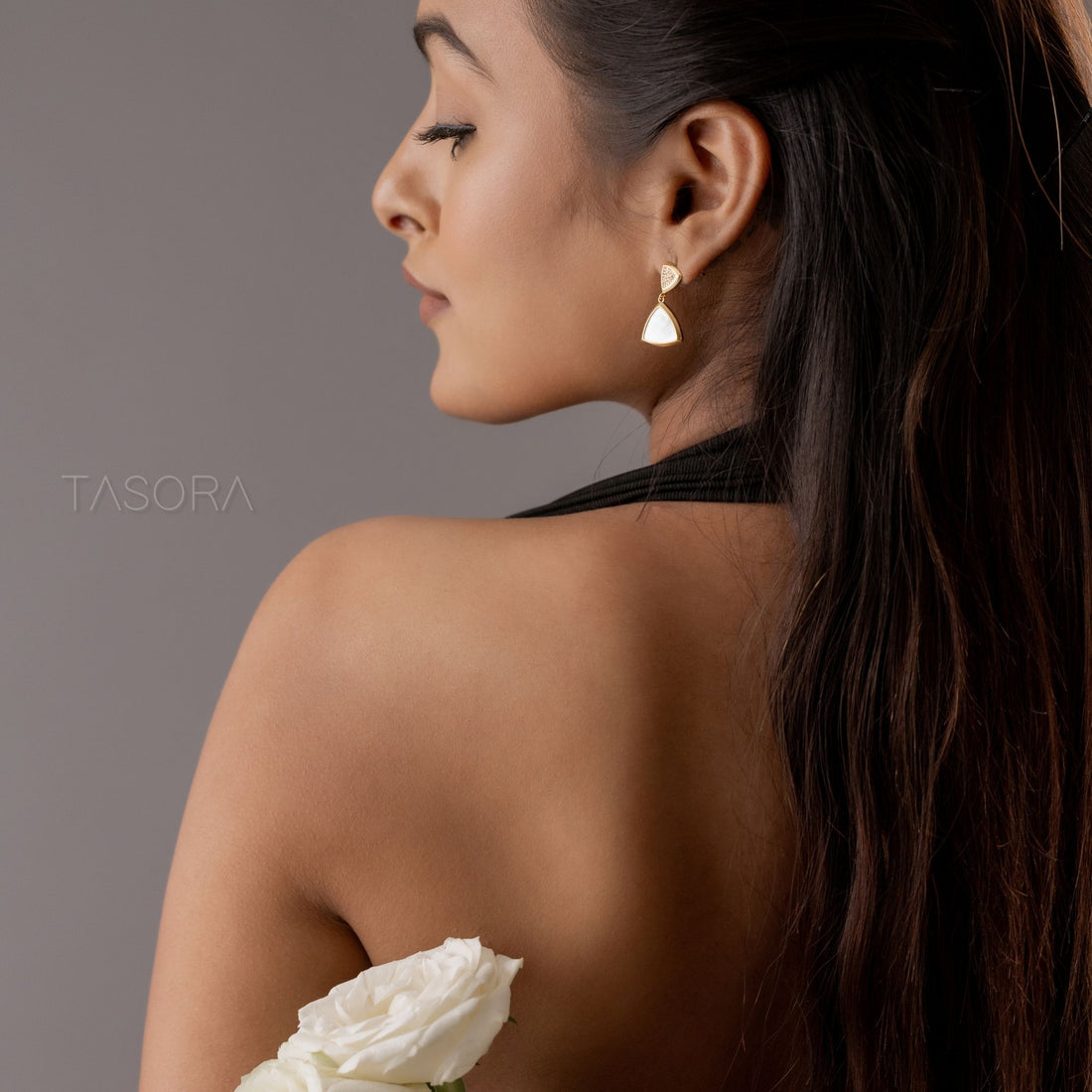 Golden and silver triangle-shaped Gleamlet earrings on a light gray surface with 'TASORA' branding.