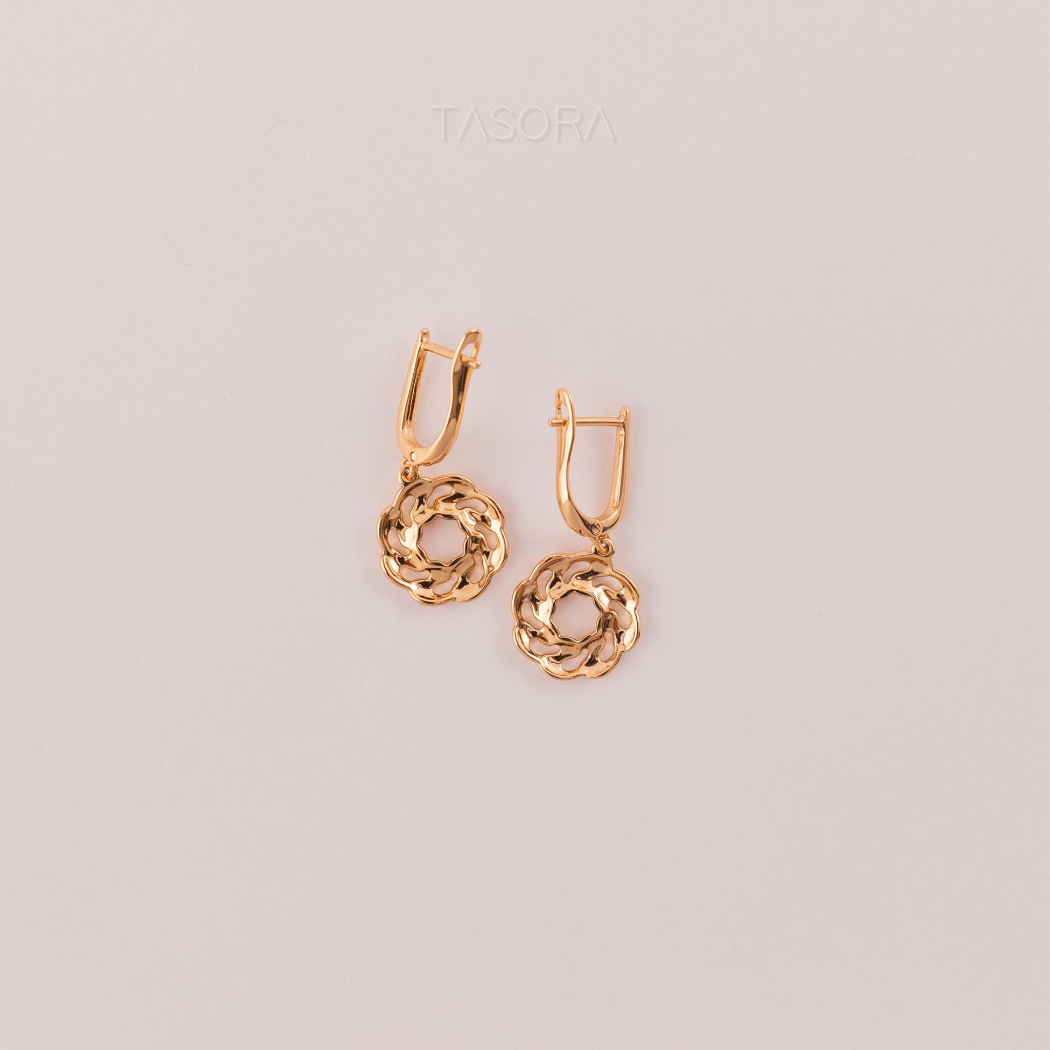 Back side of Orbbit Bloom golden hoop earrings on a light gray background with 'TASORA' branding.