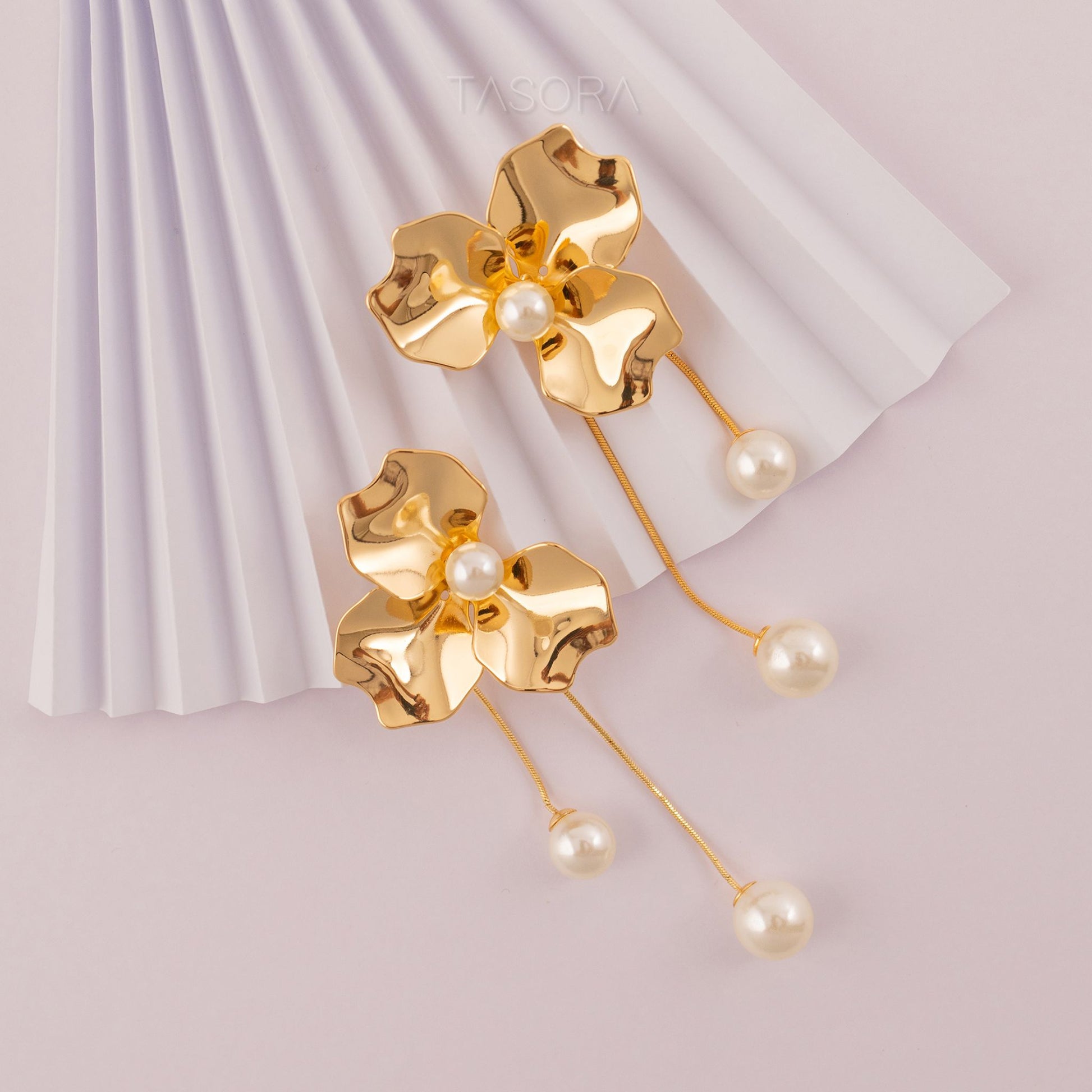 Gold floral Orchid Pearls earrings with pearl accents on a light background with TASORA branding