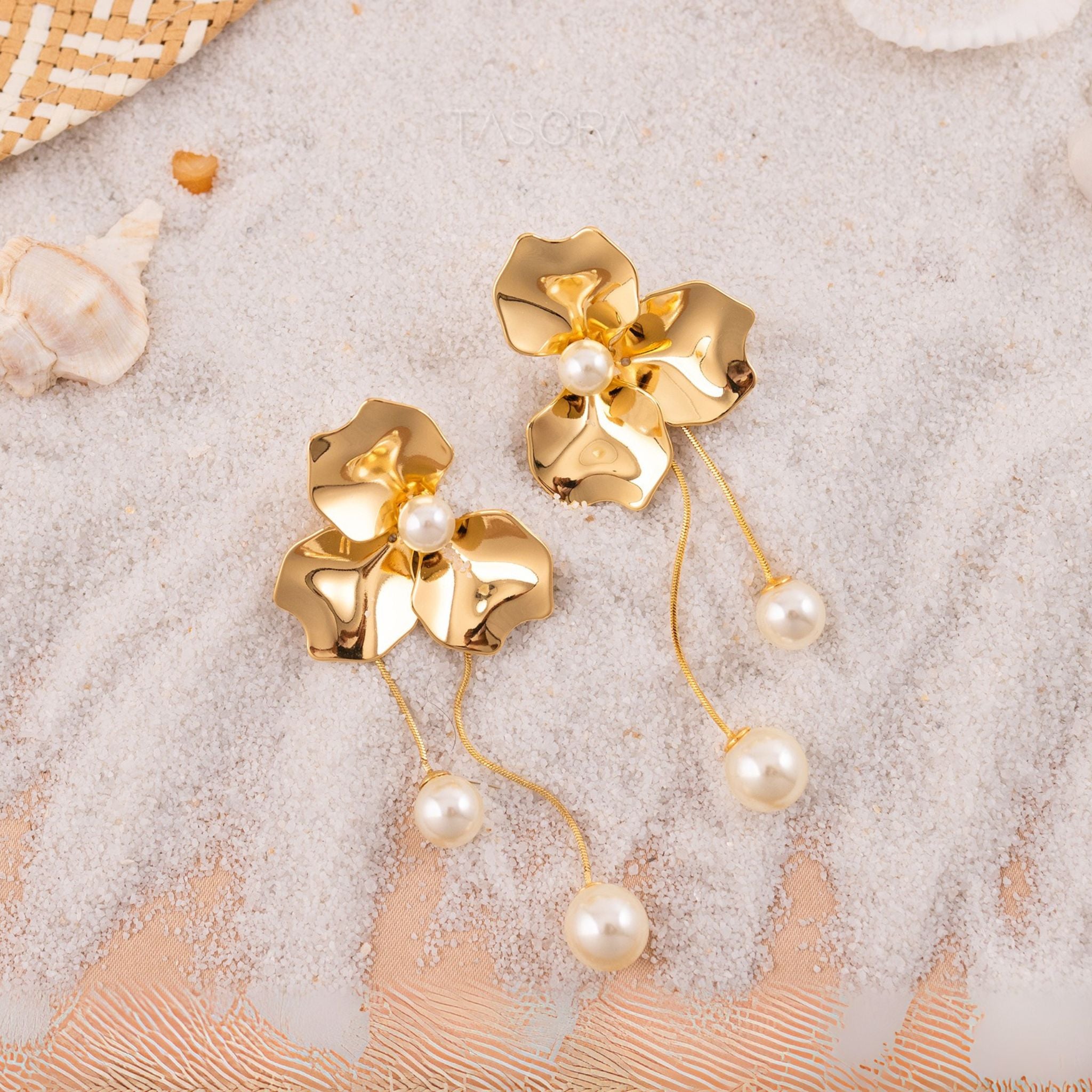 Golden floral Orchid Pearls earrings of TASORA branding on a Sea sand surface