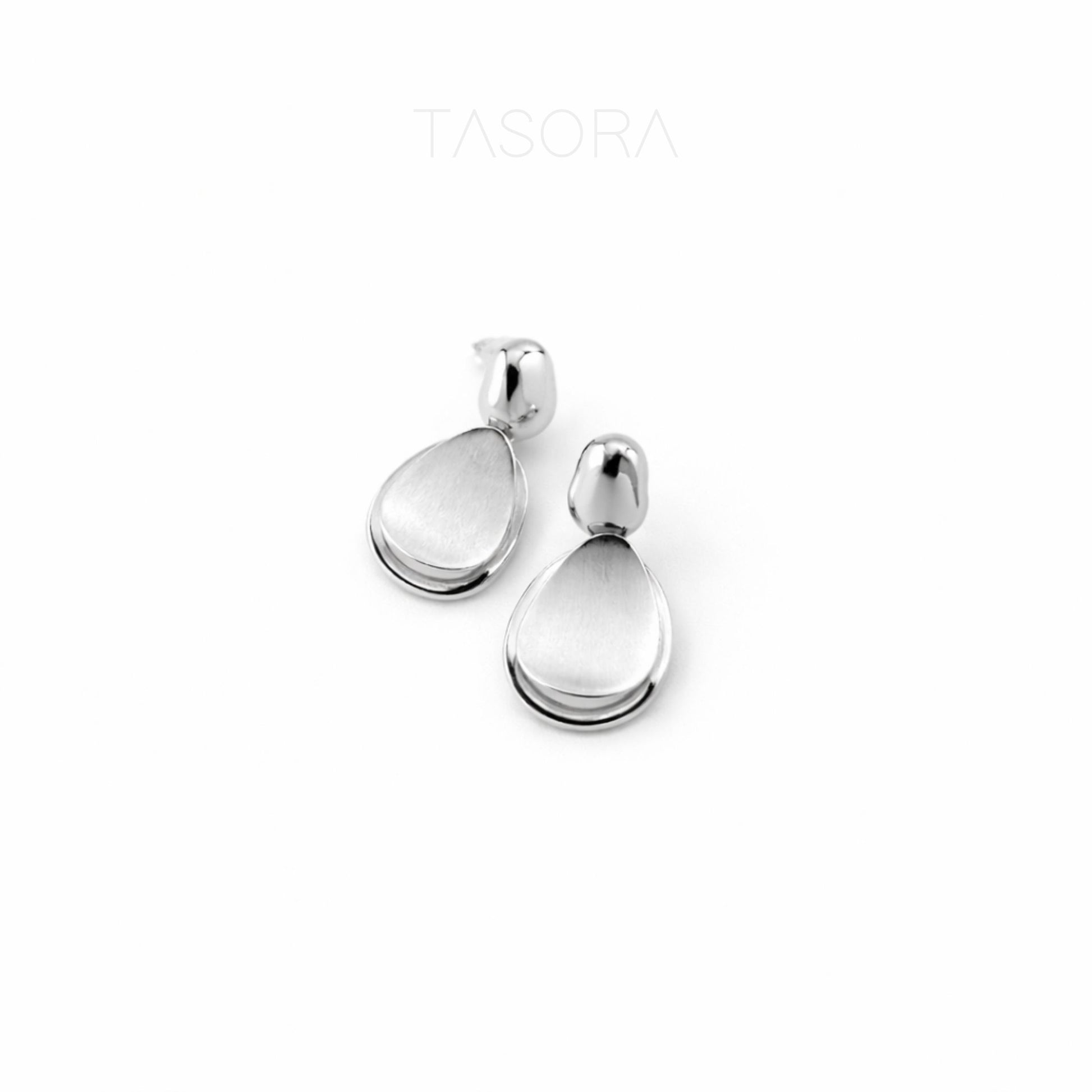 Silver teardrop earrings on a white background with 'TASORA' branding.