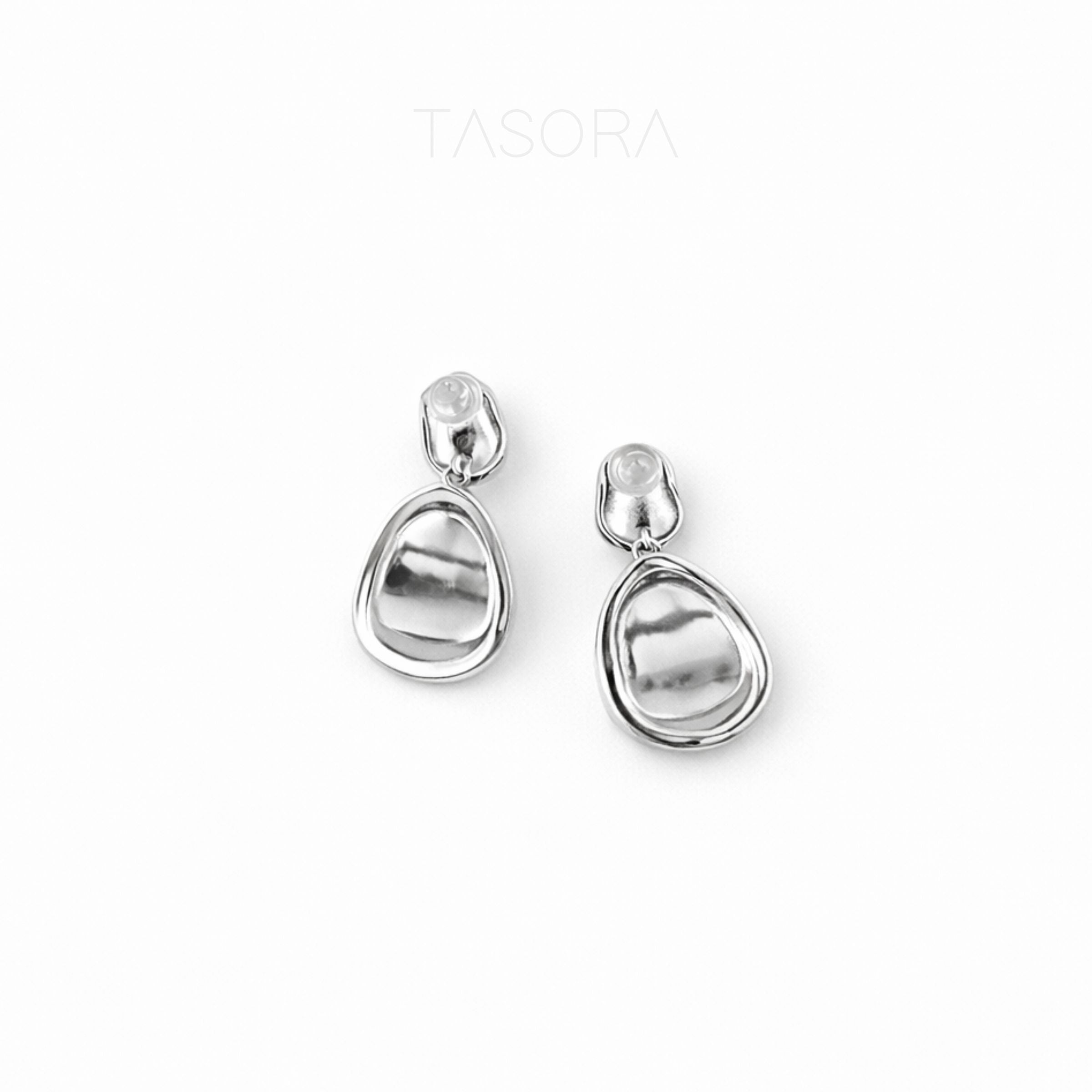Pair of silver teardrop earrings on a white background with 'TASORA' branding.