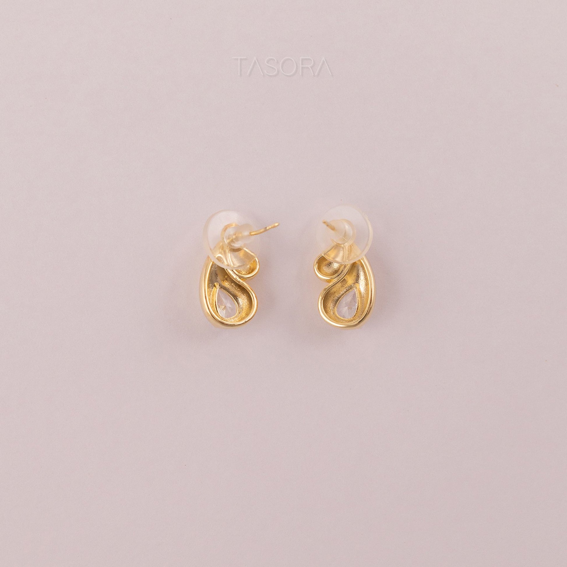 Back side of Rain Drop Golden earrings on a light gray background with 'TASORA' branding.