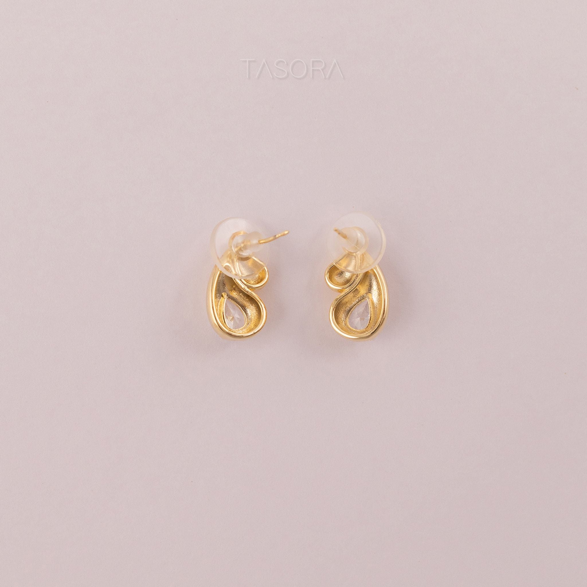 Back side of Rain Drop Golden earrings on a light gray background with 'TASORA' branding.