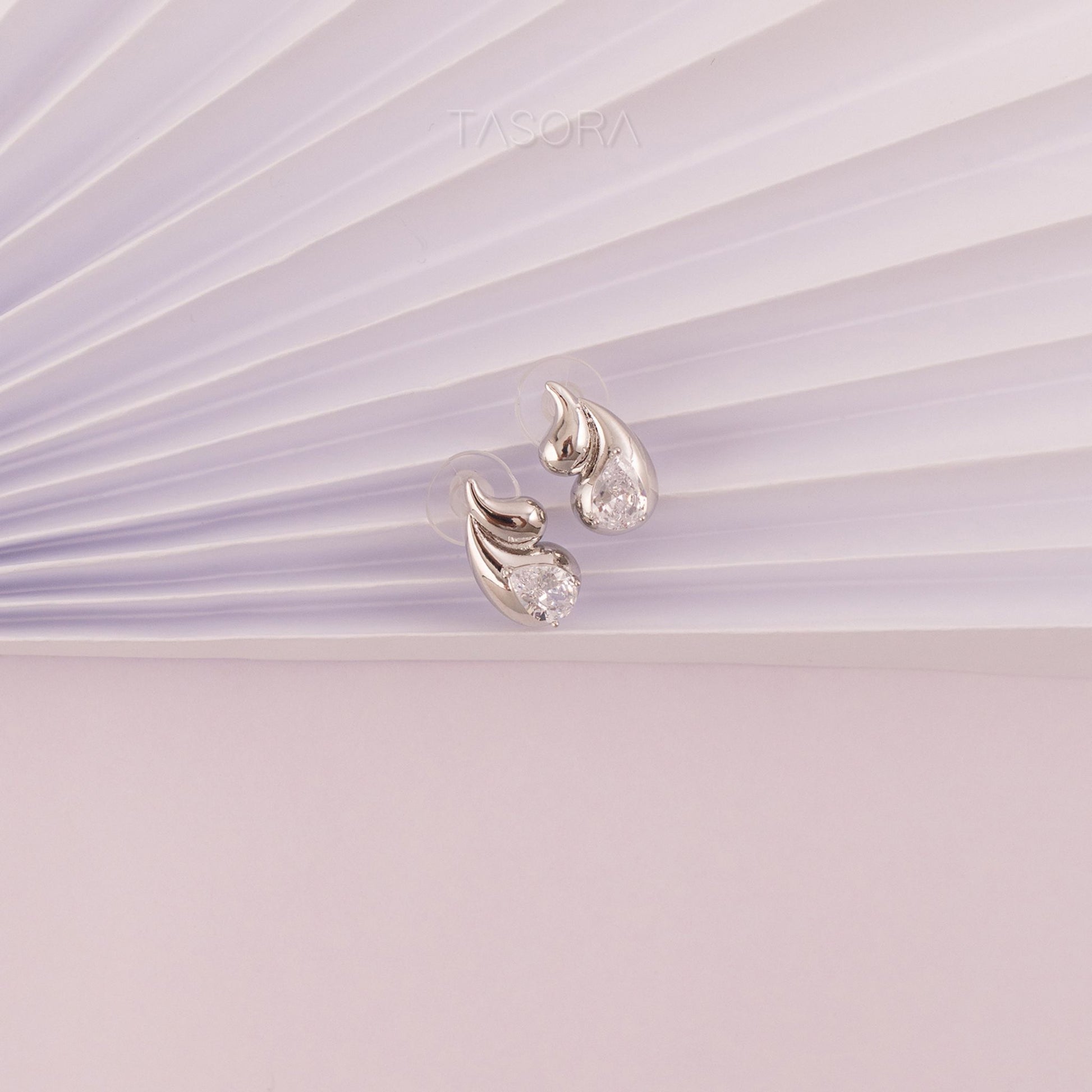 Front Side of Rain Drop Silver earrings on a light paper background