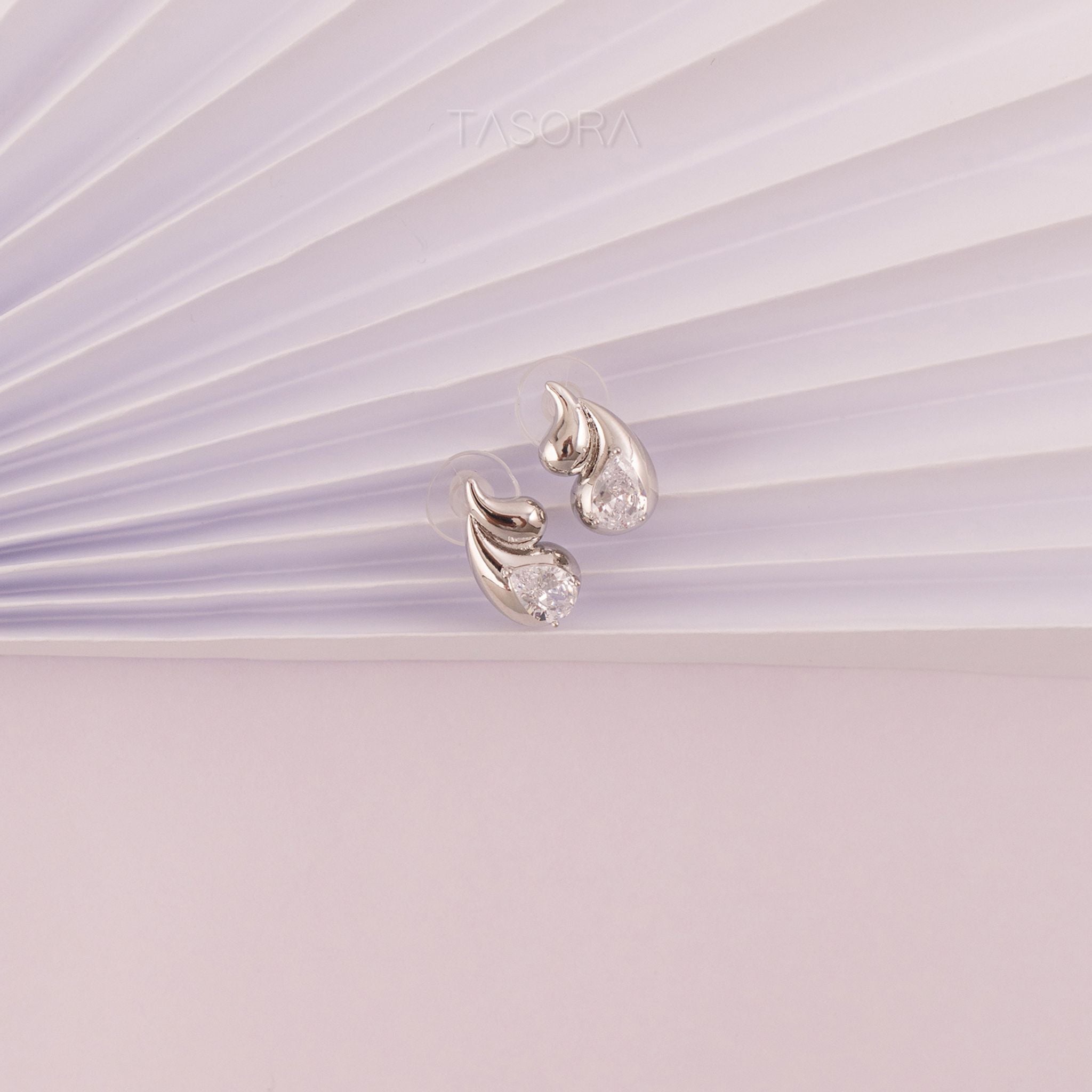 Front Side of Rain Drop Silver earrings on a light paper background