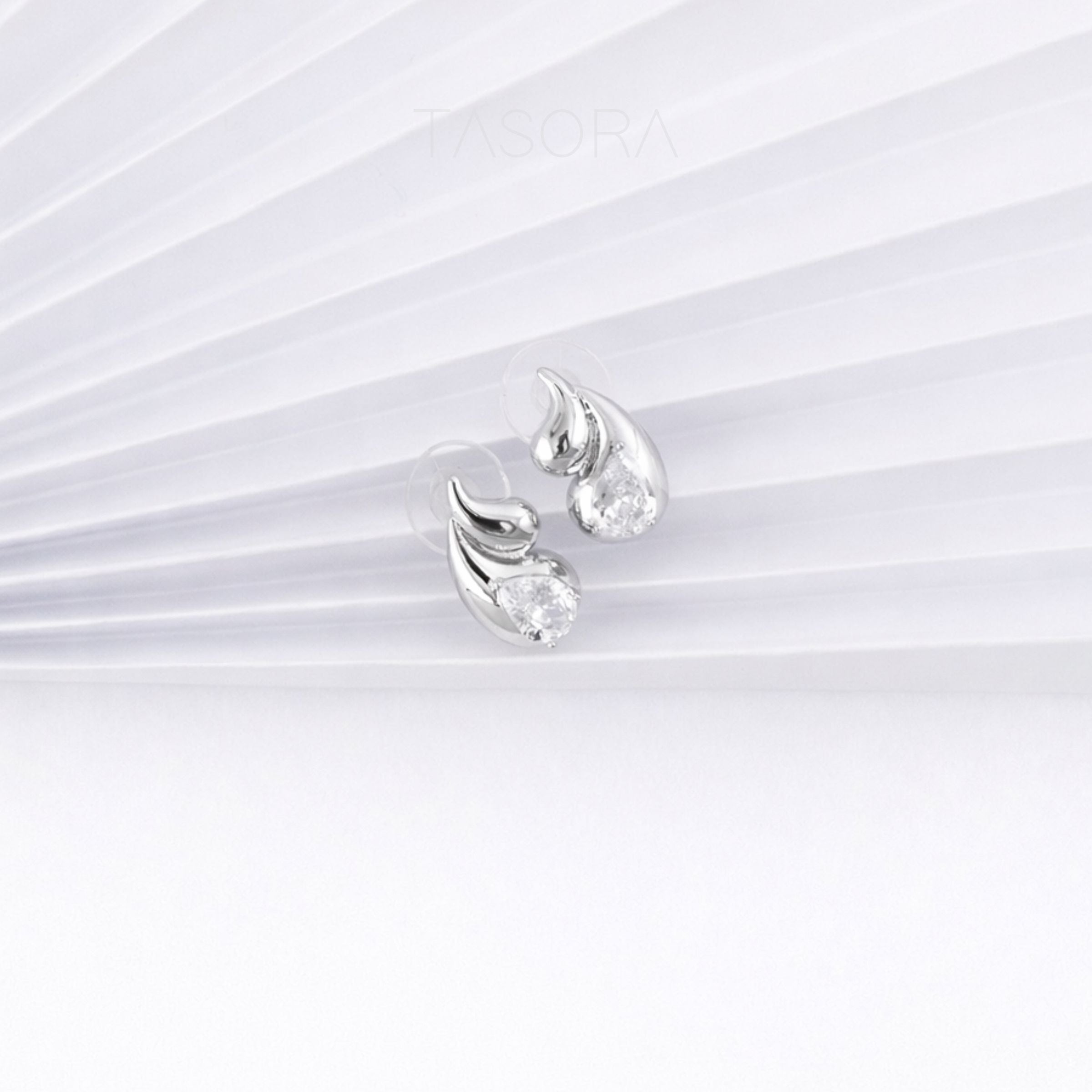 Pair of silver earrings on a white background