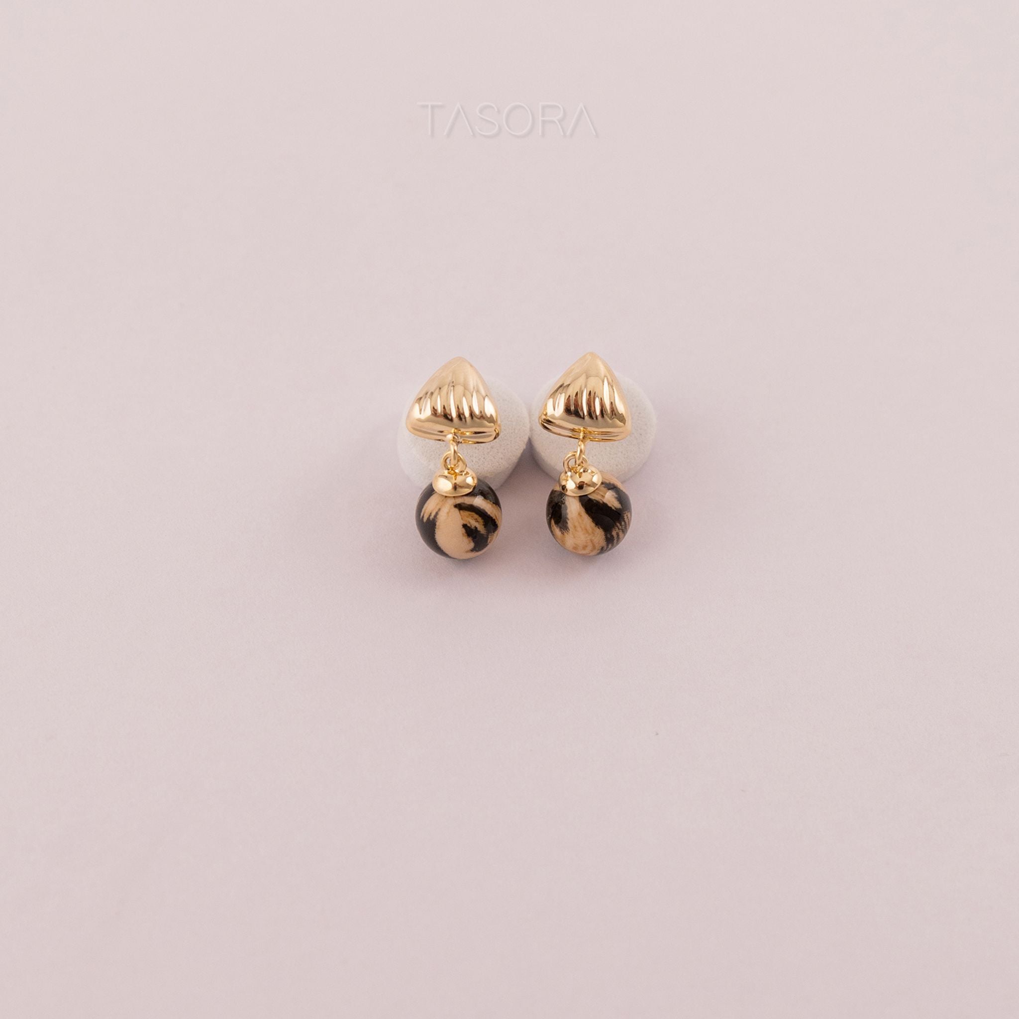 Pair of Sona Halo earrings gold and black colour on a light gray background with TASORA branding